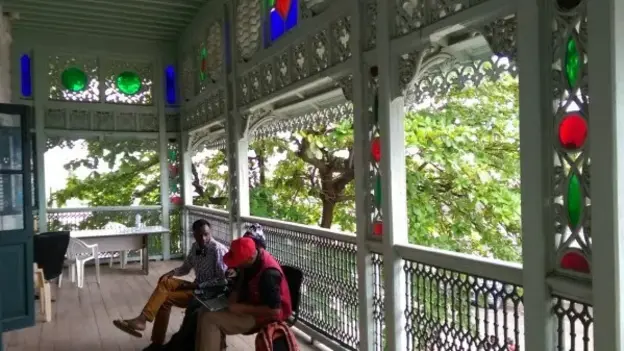 Two men talking to each other on a terrace