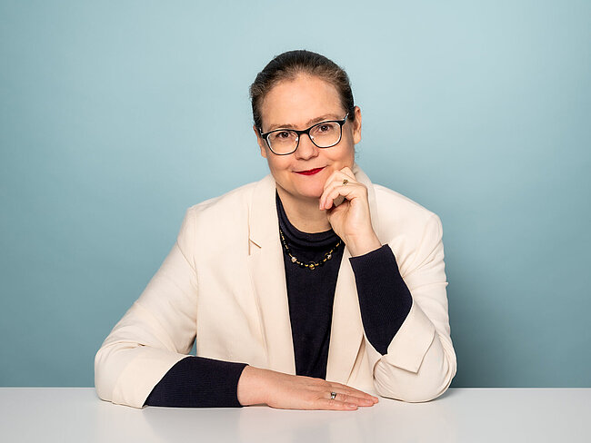 Portrait of Verena Lepper sitting at white table
