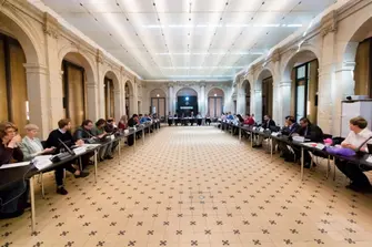 Picture of the conference room with the participants sitting on their seats