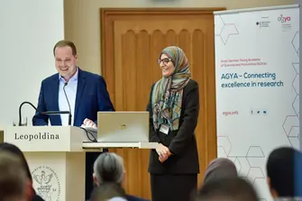 Konstantin Klein and Olfa Messaoud standing at a podium