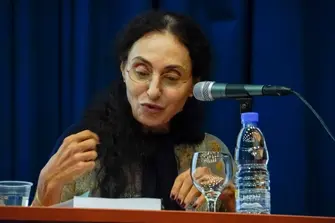A woman speaking in a microphone