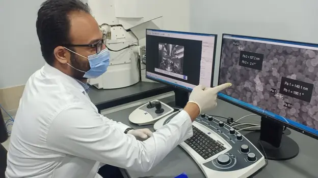 Scientist working with a lab computer