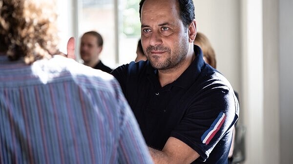 A man demonstrating something to another person