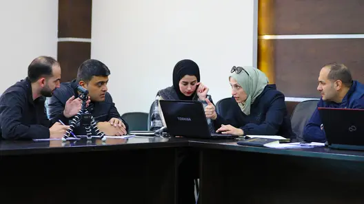 Two women and three men discussing something during the conference