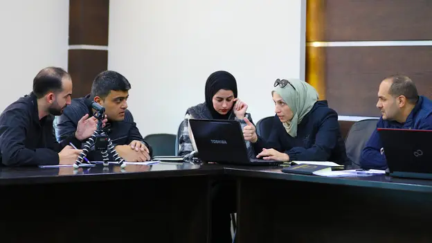 Two women and three men discussing something during the conference