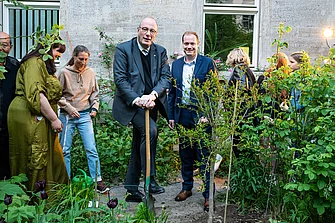 Prof. Markschie and Prof. Klein standing in front of a freshly plantes tree