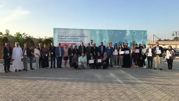 Group of participants in front of the workshop roll up