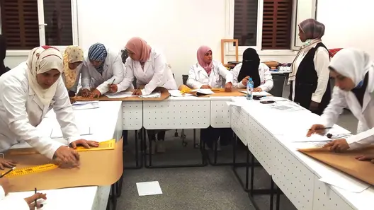 A group of women measuring and sketching in a work process